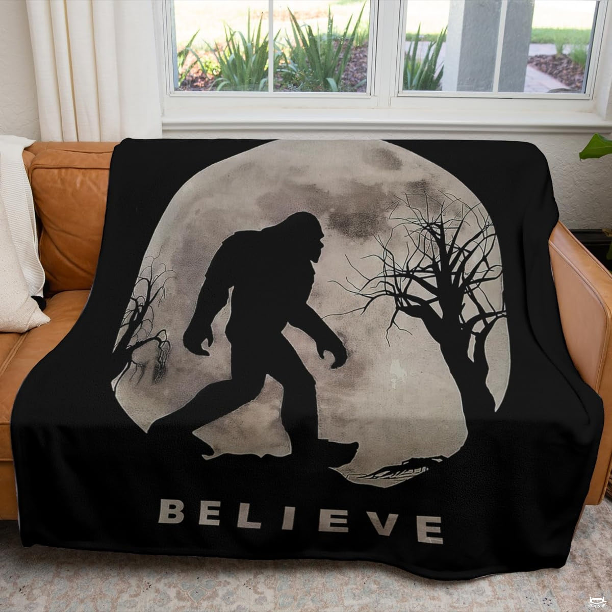 Cryptid home decor artwork showcasing Sasquatch silhouette walking beneath luminous thematic accent moon