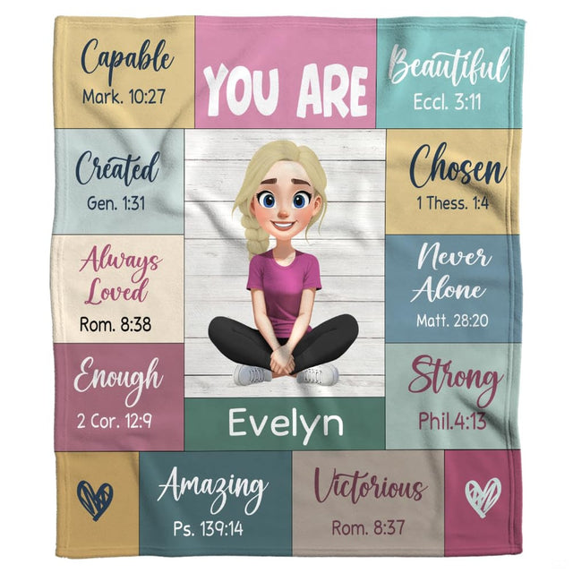 Overhead perspective of bedding featuring colorful affirmation blocks and delicate heart doodles.