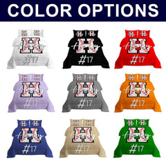 Top view of varsity sports layout on royal bedding set in blue.