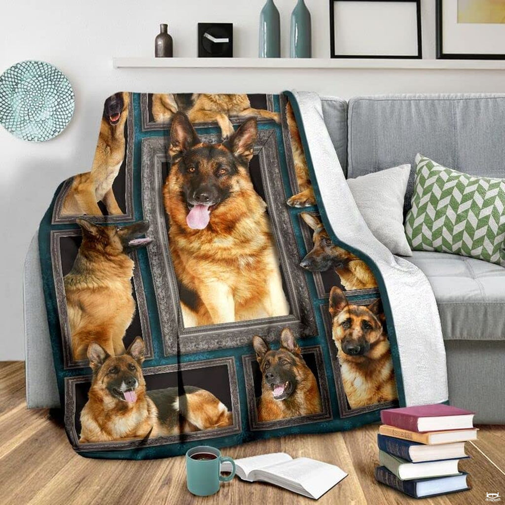 Close-up of German Shepherd canine artwork in ornate frames on dark teal damask.