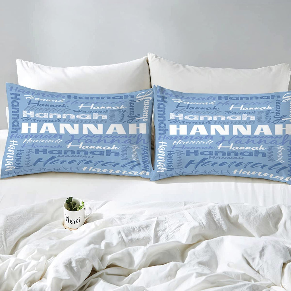 Overhead view of periwinkle typography bedding spread across a contemporary bedroom bed