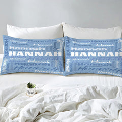 Overhead view of periwinkle typography bedding spread across a contemporary bedroom bed