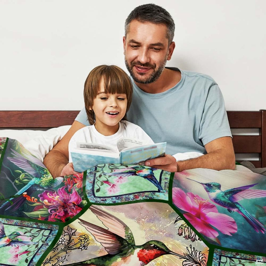 Vibrant hummingbird collage bedding styled neatly on a bed within a bright, contemporary interior space.