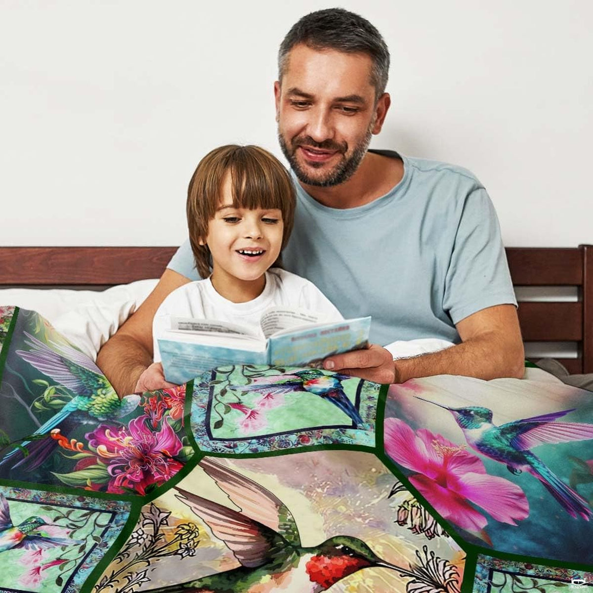 Vibrant hummingbird collage bedding styled neatly on a bed within a bright, contemporary interior space.