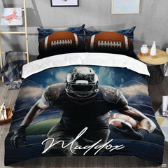 Close-up perspective of football bedding detailing helmet cage, cursive script lettering, and textured football
