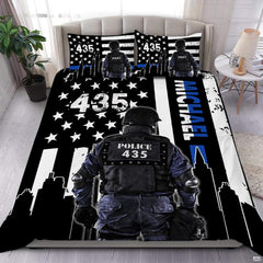 Rear-facing tactical figure over a black-and-white flag, blue stripe, white stars, and city skyline