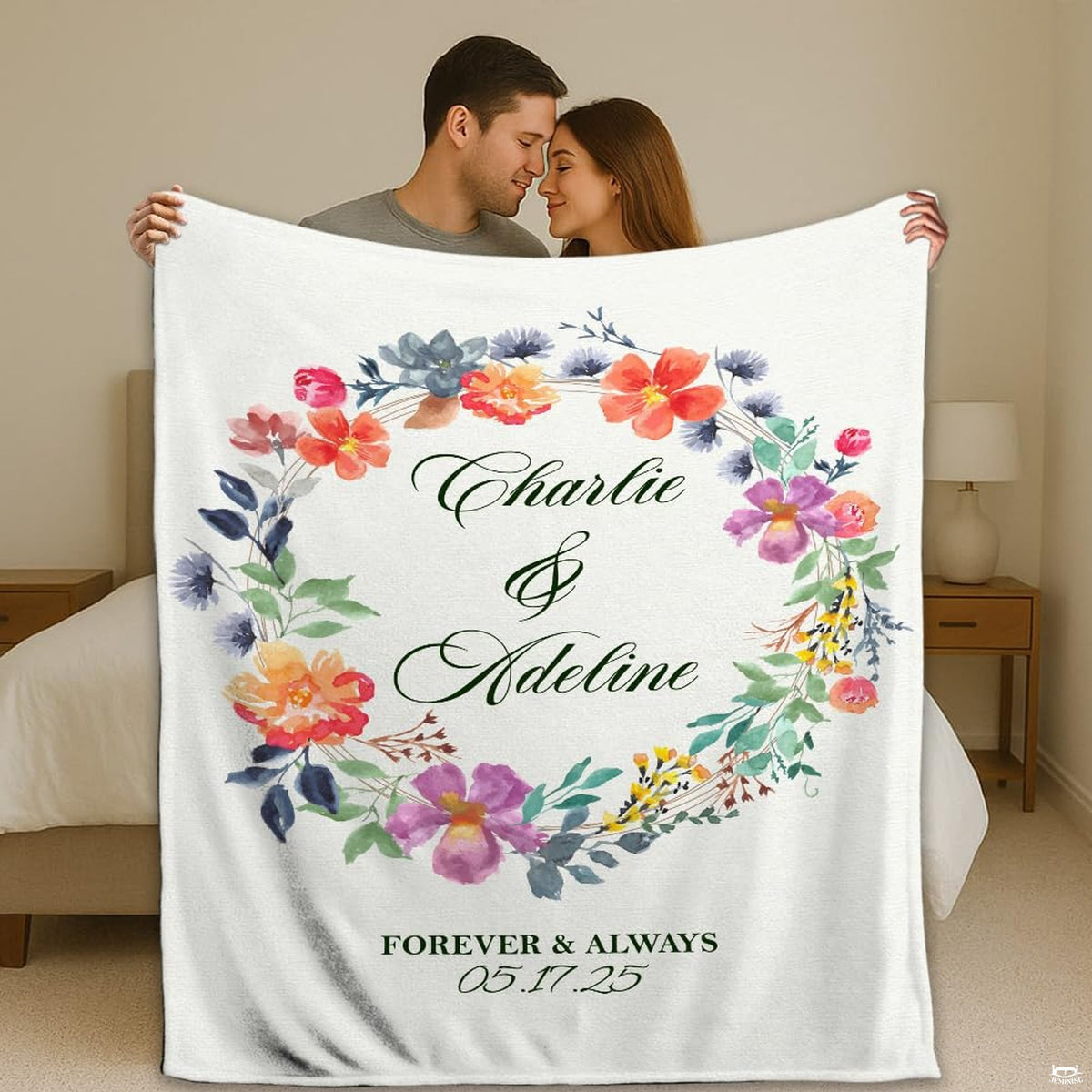 Wedding gift bedding showcasing a circular watercolor floral wreath with coral and lavender blossoms on white.