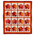 Autumn maple leaf geometric grid throw blanket featuring faceted crimson and amber leaf panels on speckled ivory