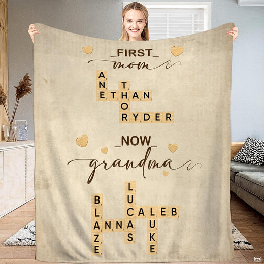 First Mom Now Grandma crossword tile throw blanket held open by woman