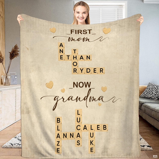 First Mom Now Grandma crossword tile throw blanket held open by woman