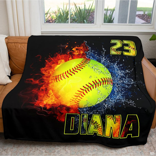 Fire and water sports textile arranged across a brown living room couch facing a window.