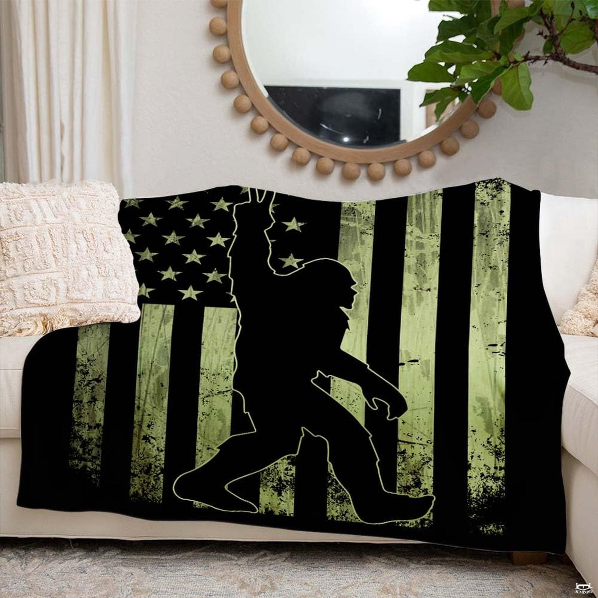 Folded tactical green Bigfoot American flag throw blanket resting on wooden table displaying flag print