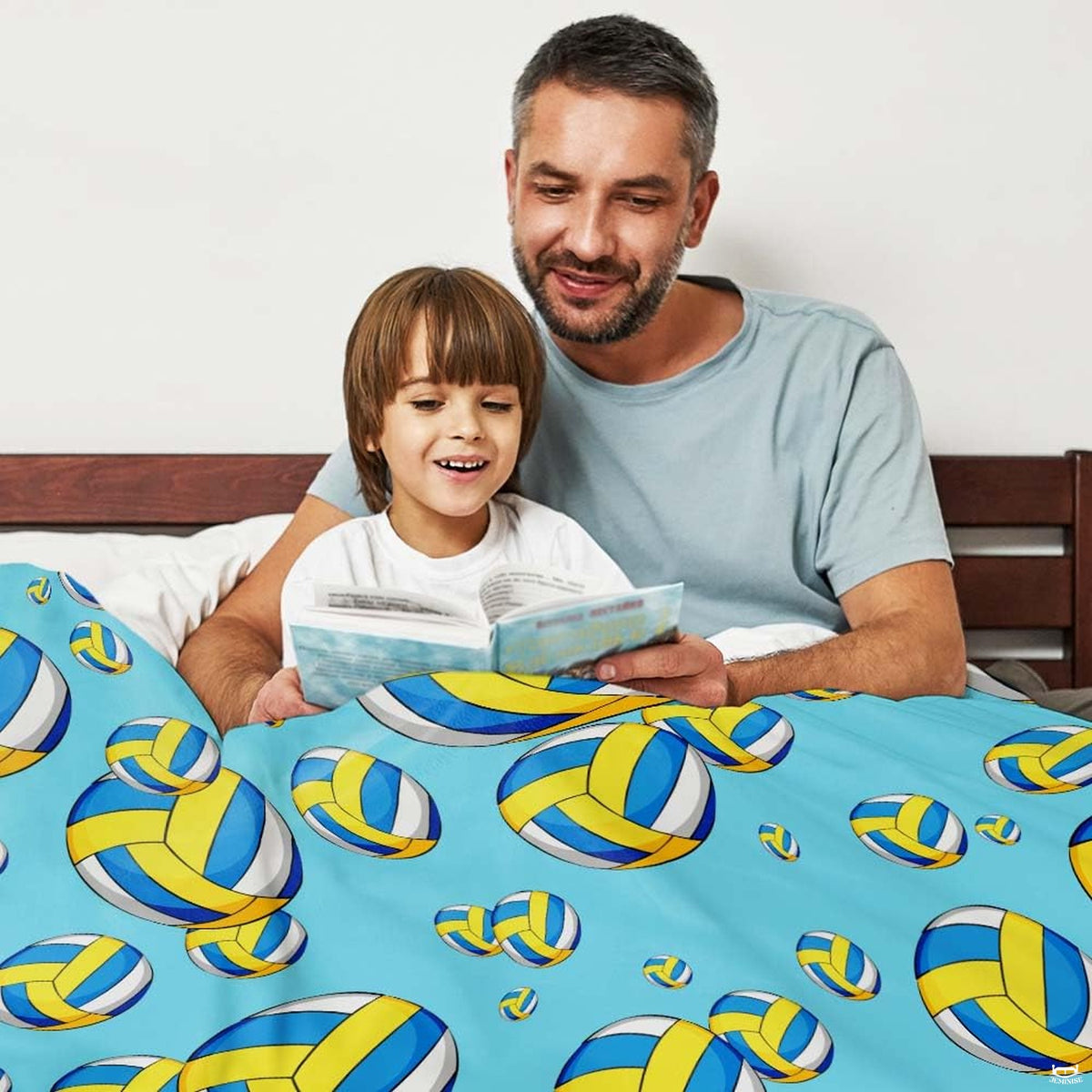 Close up view of the sporty volleyball graphics and graphic accent stripe detailing on sky blue bedding.