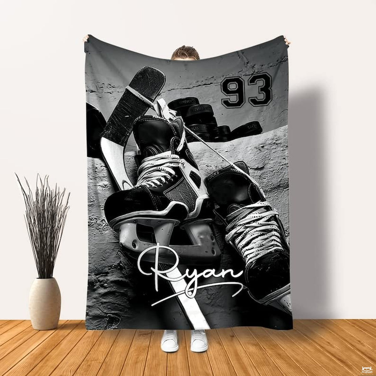 Ice hockey skates stick pucks sports blanket held up displaying hockey gear