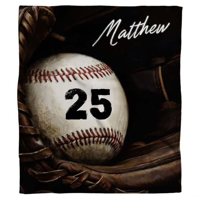 Realistic baseball with crimson lacing resting inside a fielder mitt against dark shadows, view 1.