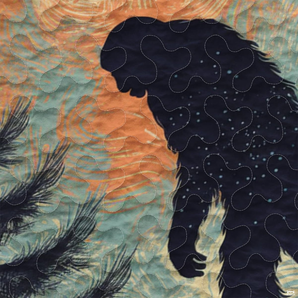 Close-up view of Bigfoot bedding showcasing retro sunset stripes, evergreen pines, and Sasquatch silhouette