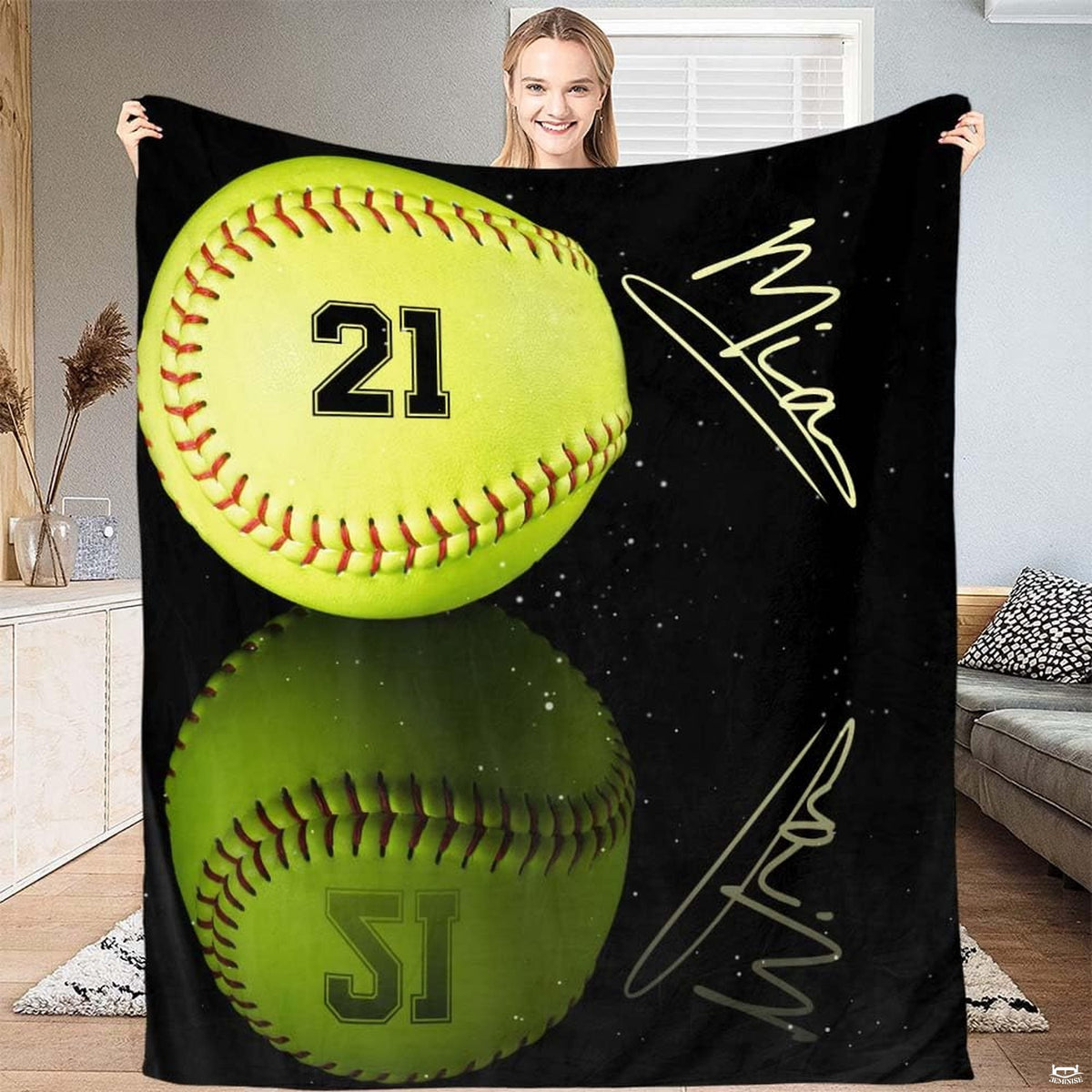 Softball blanket held high displaying full optic yellow ball graphic in living room