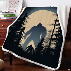 Bigfoot pair blanket draped on armchair featuring dual Sasquatch figures under full moon.
