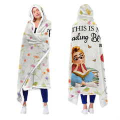 Memorial blanket featuring angel wings and floral graphic displayed over bedroom bedding.