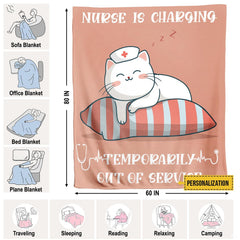 Folded sleeping nurse cat cartoon throw blanket resting on wooden table displaying pink artwork