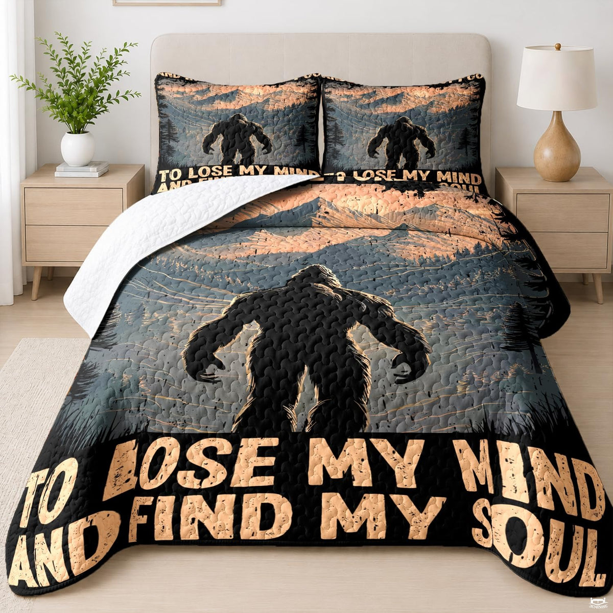 Bigfoot silhouette walking through evergreen pine trees on a mountain style bedding set display.