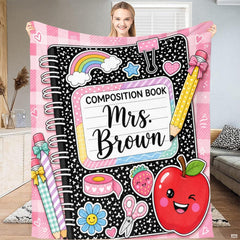 Stationery doodle bedding set featuring a speckled notebook pattern, pink gingham trim, and smiling red apple artwork.