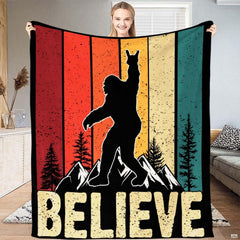 Rock on Bigfoot silhouette atop snowy mountain peaks with retro sunset stripes, view 1.