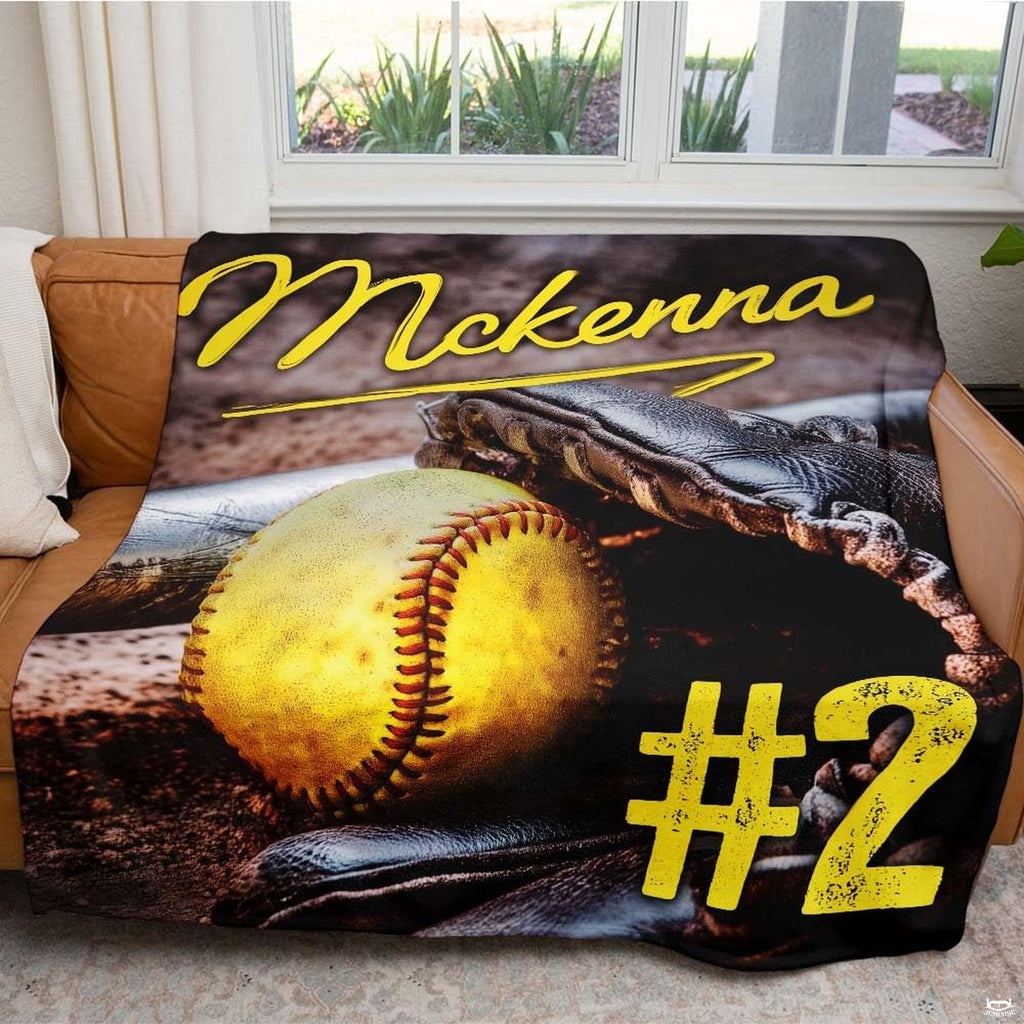 Close view of optic yellow ball and fielder glove on blanket