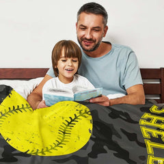Camo fastpitch softball blanket folded neatly in bedroom space