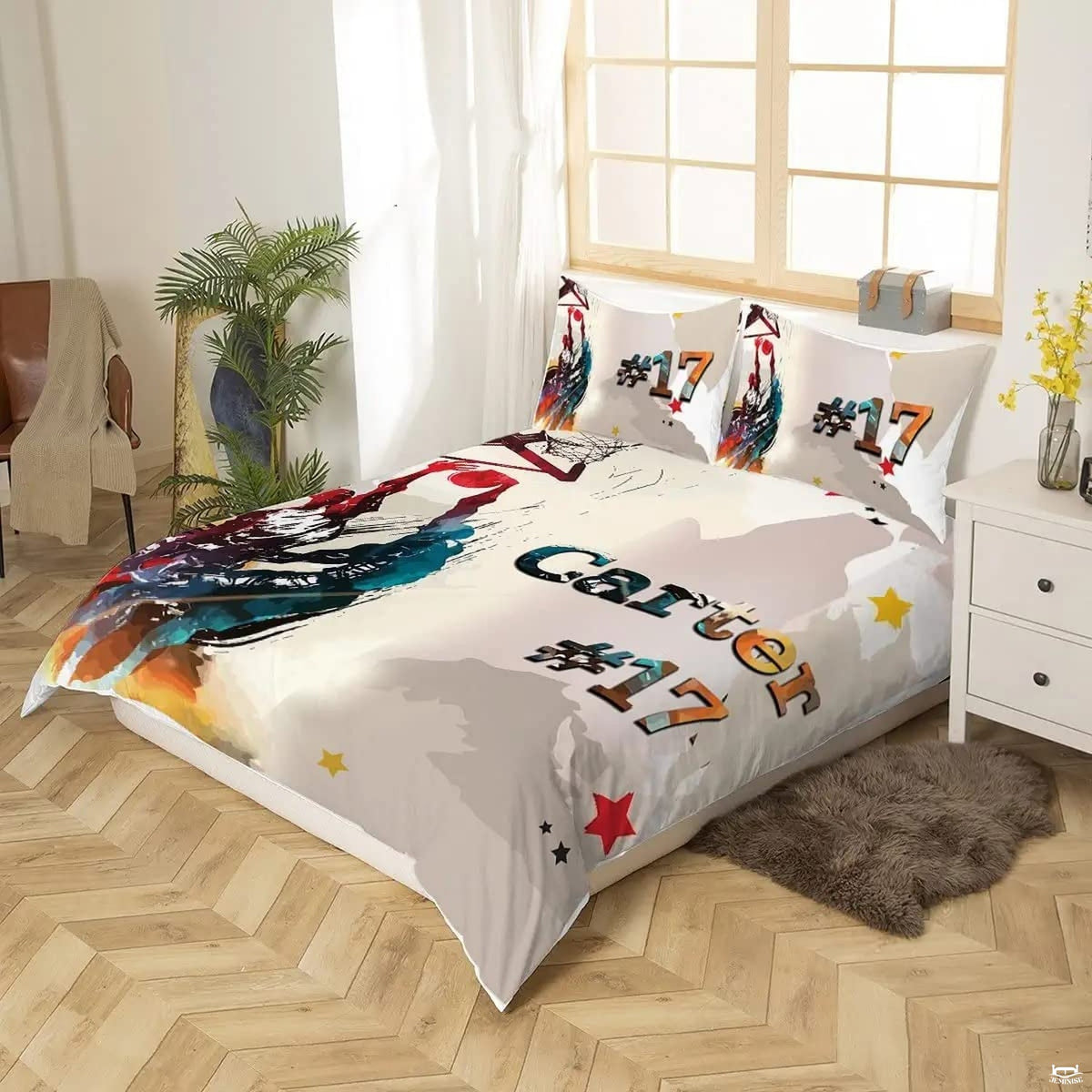 Detail angle of painterly splatter textures and crimson teal athletic tones on cream bedding