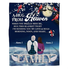 Woman holding open memorial angel cardinals tree throw blanket in sunny modern room