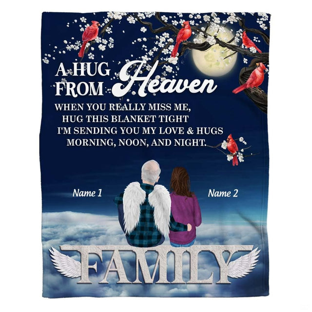 Woman holding open memorial angel cardinals tree throw blanket in sunny modern room