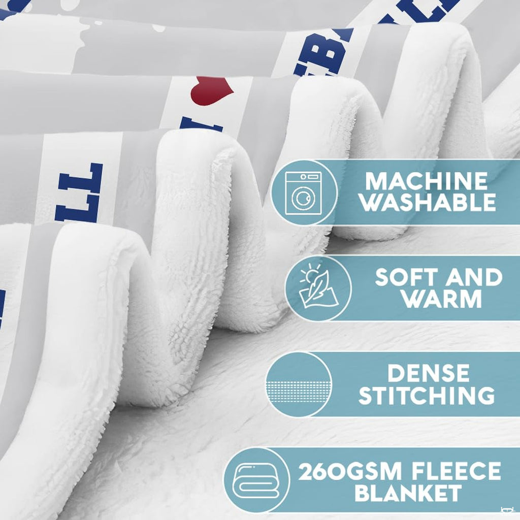 Close-up of thematic accent sports bedding graphic highlighting bold blue paint splatters and athletic borders.