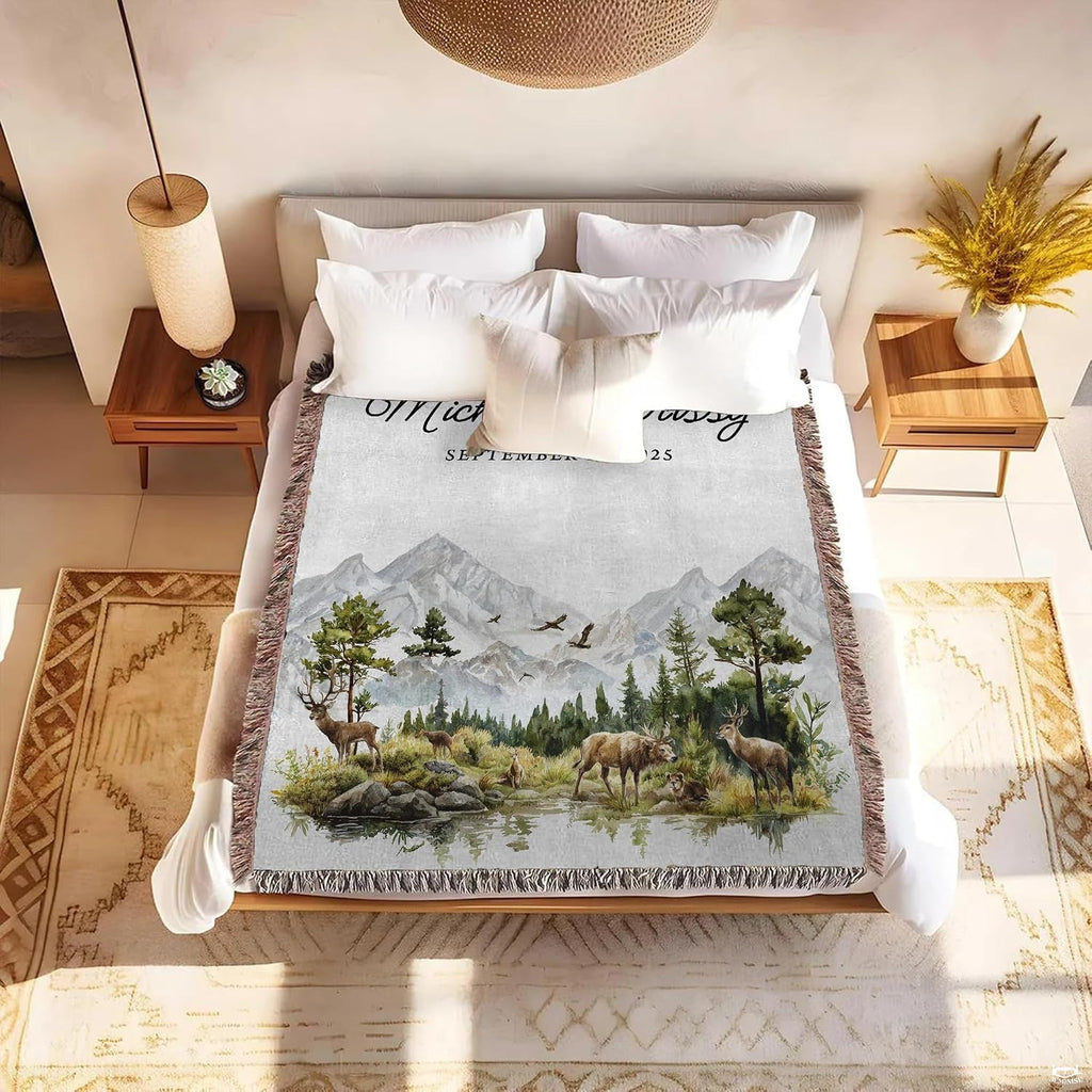 Detail of clear mountain stream reflections, forest greenery, and black script lettering on a blanket