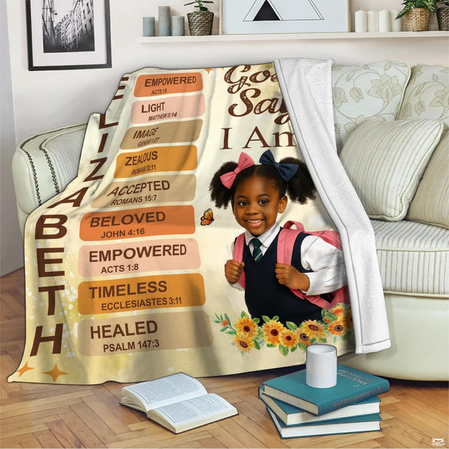 Living room sofa displaying the cheerful schoolgirl faith throw blanket draped over furniture.