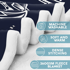 Artistic overhead angle of nautical anchor motif bedding on a styled bed.