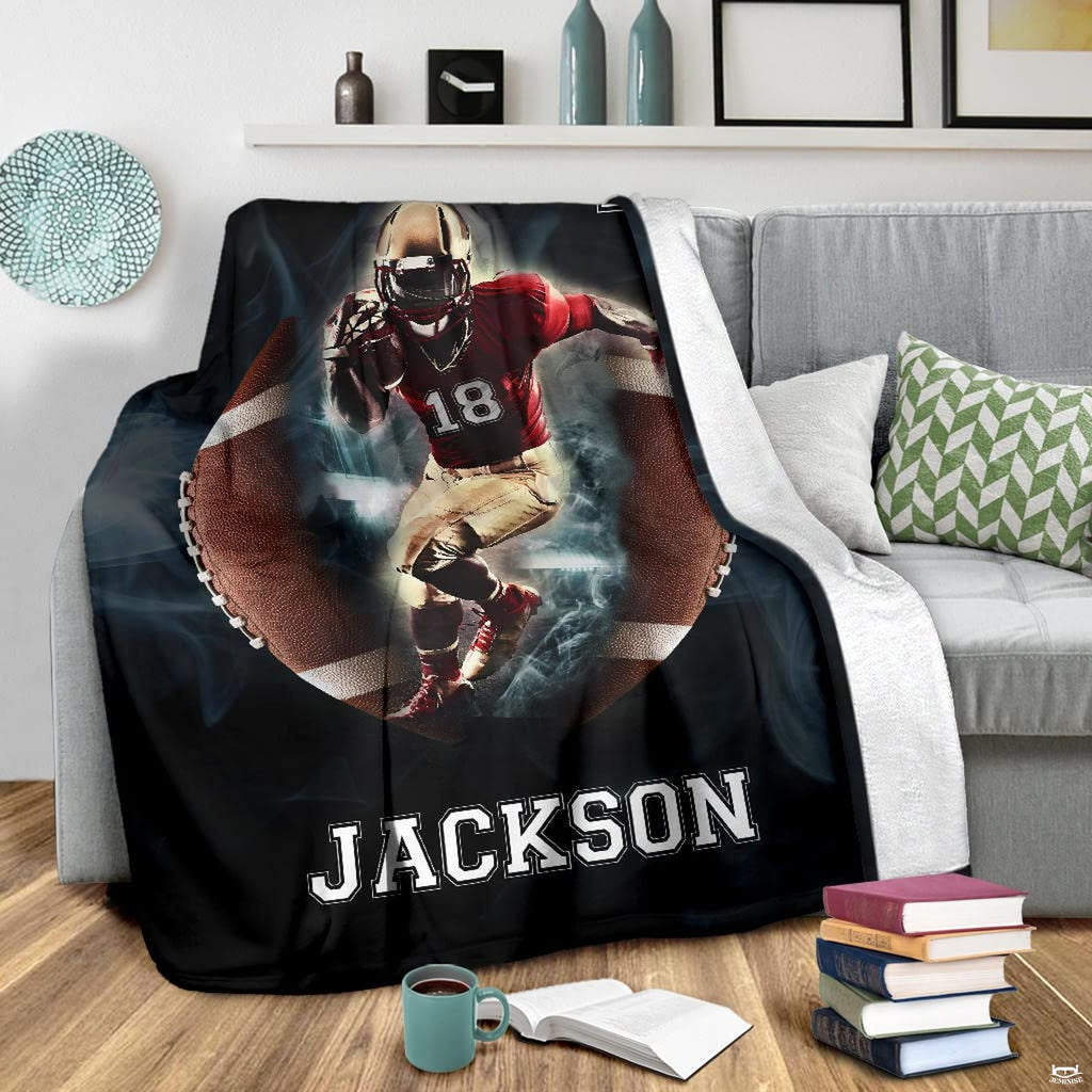 Football action graphic blanket displayed on living room armchair