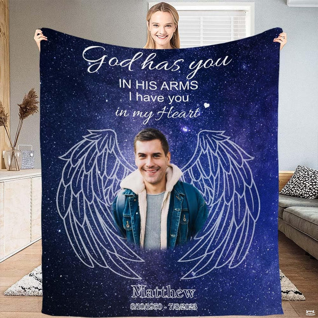 Cosmic deep blue bedding set display showing angel wings and star constellations across a deep set bed frame setup.