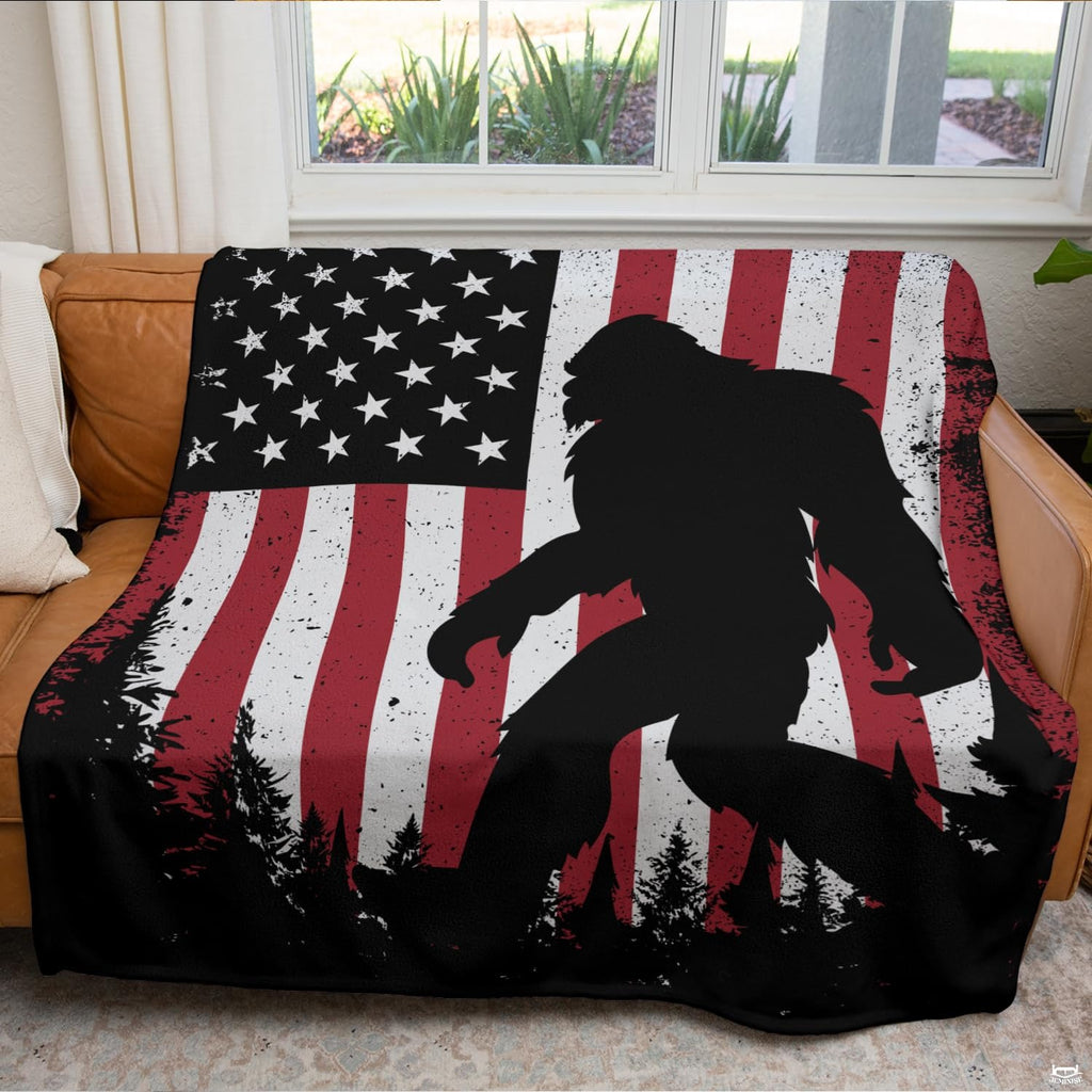 Woodland sasquatch graphic blanket arranged over living room armchair