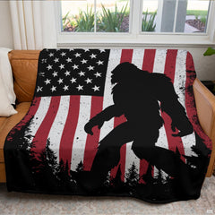 Woodland sasquatch graphic blanket arranged over living room armchair