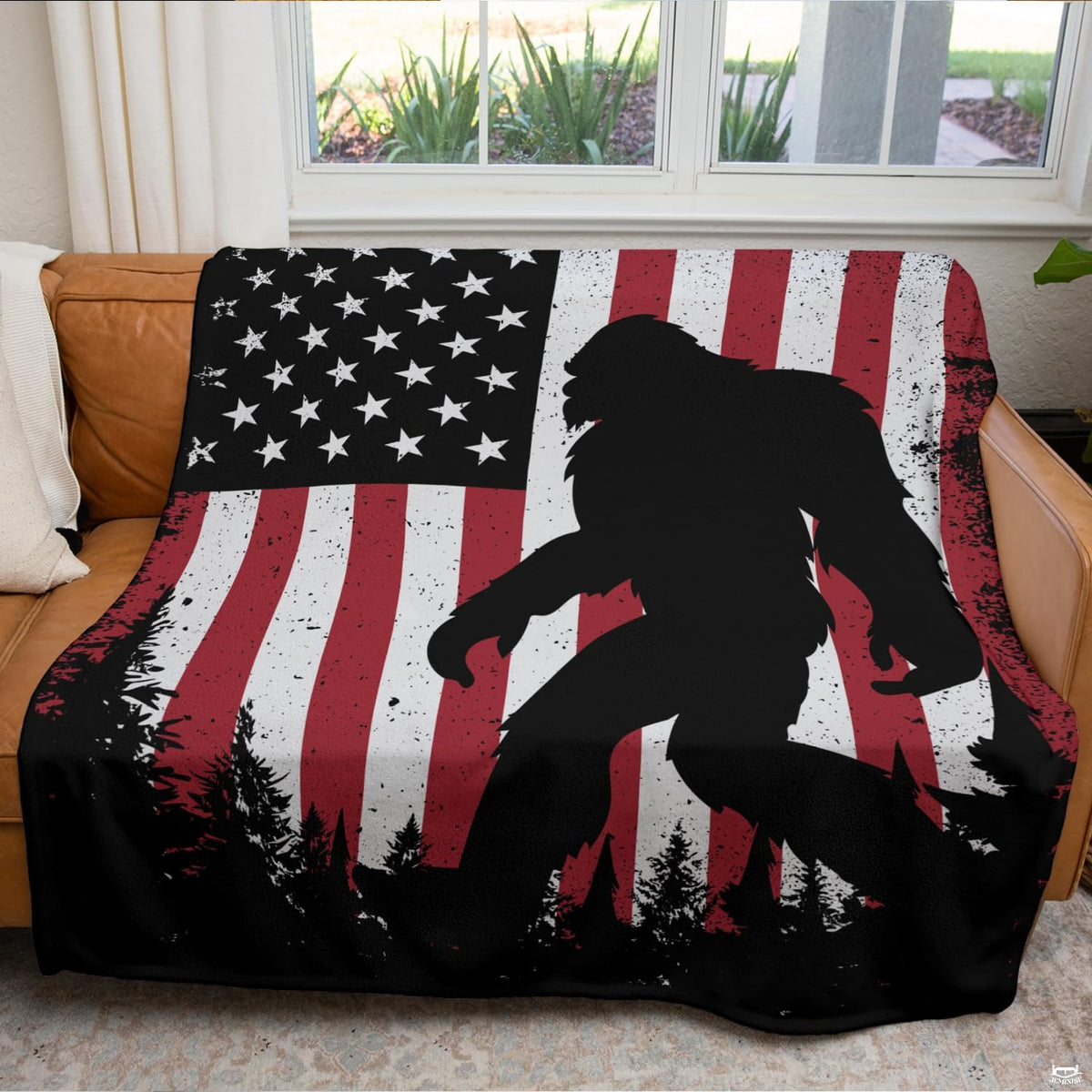Woodland sasquatch graphic blanket arranged over living room armchair