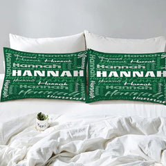 Overhead view of forest green typography bedding spread across a contemporary bedroom bed