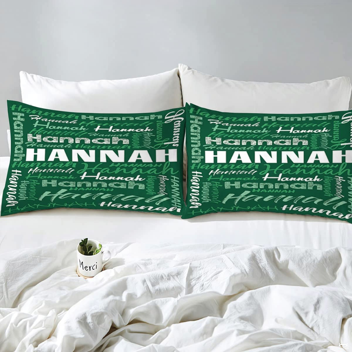 Overhead view of forest green typography bedding spread across a contemporary bedroom bed