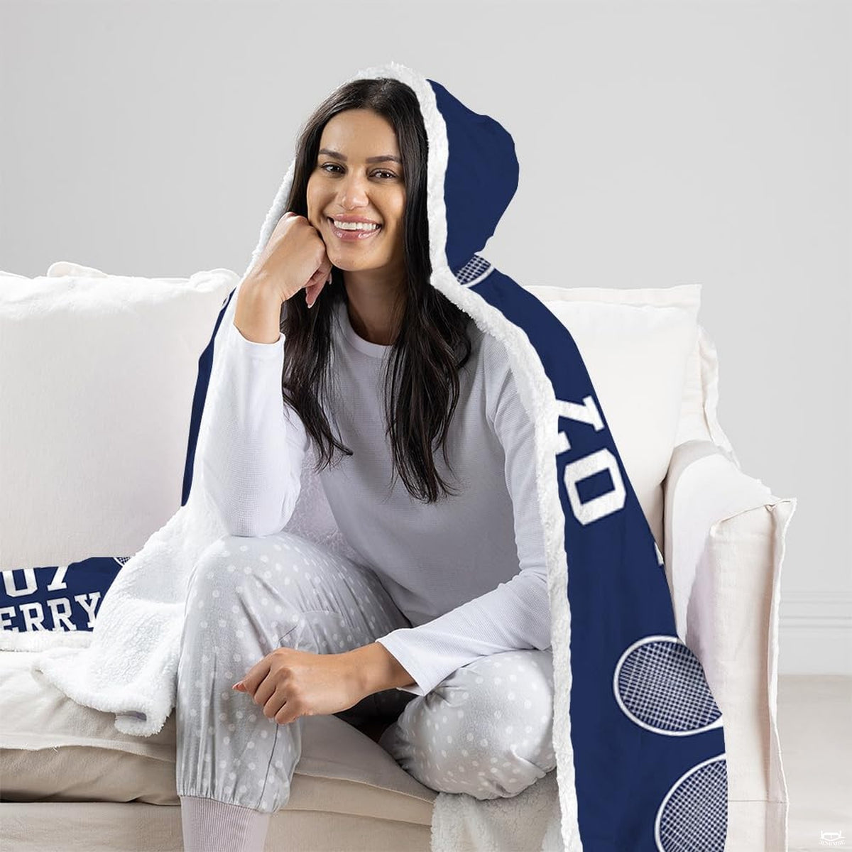 Folded corner view of tennis racket hooded blanket showing crisp white graphics