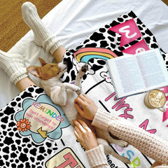 Lifestyle setting displaying the educator throw blanket neatly folded on an armchair.