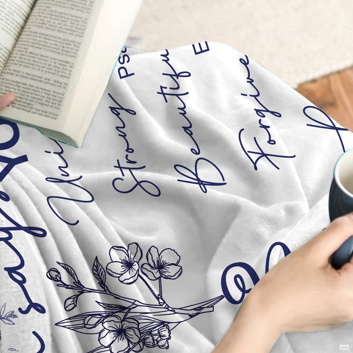 Scripture floral art throw blanket draped across a living room couch.