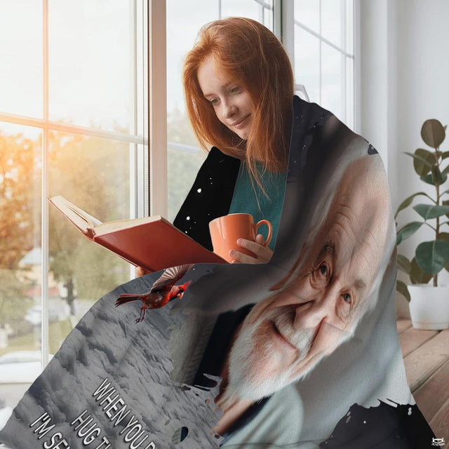 Folded remembrance throw blanket displaying the cardinal birds and portrait vignette