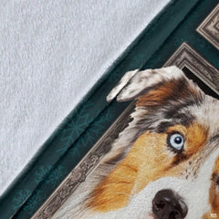 Close-up detail shot of the Australian Shepherd blanket showing edge detail and teal snowflake art.