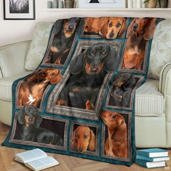 Dachshund throw blanket styled across a living room sofa near stacked books and a cup.