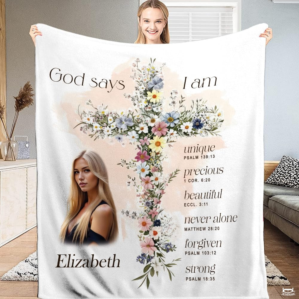 Floral cross scripture affirmations blanket held upright by model displaying wildflower cross.